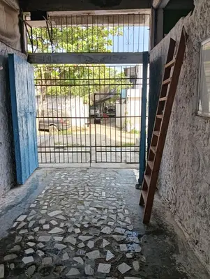 an open gate in a building with a ladder at Casamar sol caribe in Cartagena de Indias