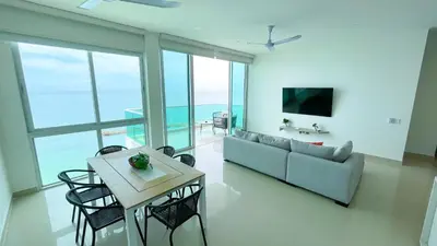 a living room with a couch and a table at Magico Apartamento Frente al Mar 3 Habitaciones BM91 in Coveñitas