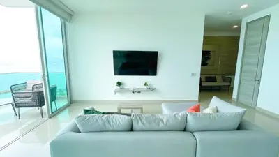 a living room with a couch and a large window at Magico Apartamento Frente al Mar 3 Habitaciones BM91 in Coveñitas