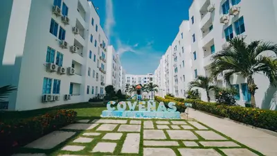 a sign that says condos in front of buildings at Caribe Familiar 504 in Coveñas