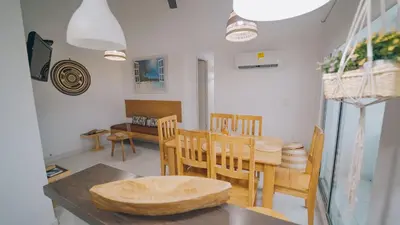 a dining room with a table and chairs at Caribe Familiar 504 in Coveñas