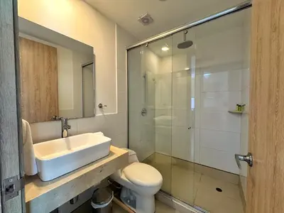 a bathroom with a sink and a toilet and a shower at Sky Collection Lifestyle Hotel & Suites Barranquilla in Barranquilla
