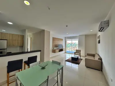 a kitchen and living room with a table and chairs at Sky Collection Lifestyle Hotel & Suites Barranquilla in Barranquilla