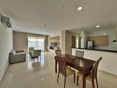 a kitchen and living room with a table and chairs at Sky Collection Lifestyle Hotel & Suites Barranquilla in Barranquilla