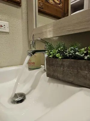 a bathroom sink with water coming out of a faucet at Exclusive Apartment with Private Jacuzzi in Cartagena de Indias