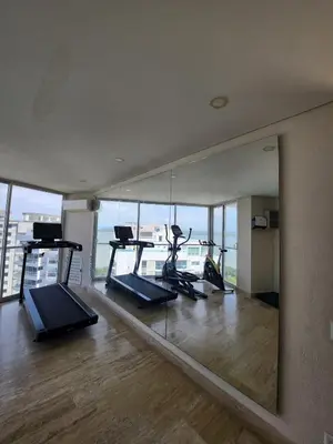 a gym with several exercise bikes and a mirror at Exclusive Apartment with Private Jacuzzi in Cartagena de Indias