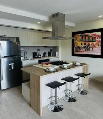 a kitchen with a island with bar stools at Exclusive Apartment with Private Jacuzzi in Cartagena de Indias