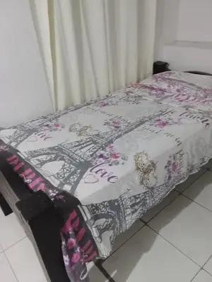 a bed with a pink and white blanket on it at hotel restaurante doña nerta in Cartagena de Indias