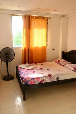 a bedroom with a bed and a window at Hotel donde Tito in Tolú