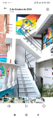 a staircase with a painting on the side of a building at Hotel donde Tito in Tolú