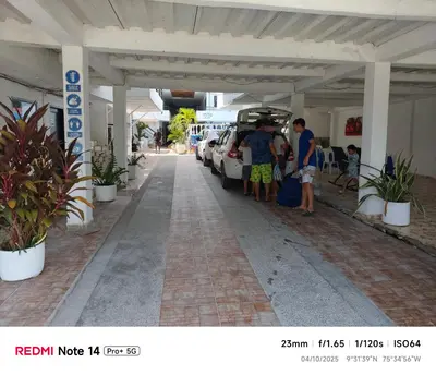 a group of people standing next to a parking lot at Hotel donde Tito in Tolú