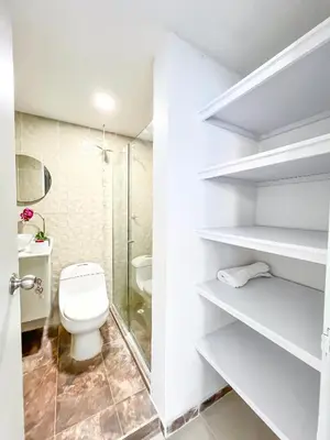 a white bathroom with a toilet and a shower at Azul Caribe 104 in Coveñas