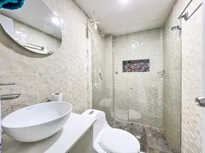 a bathroom with a sink and a toilet and a shower at Azul Caribe 104 in Coveñas