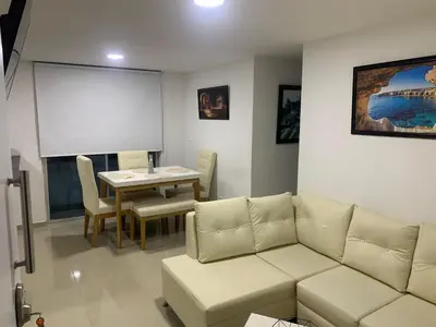 a living room with a couch and a table at Prada Caribe 303 in Coveñas