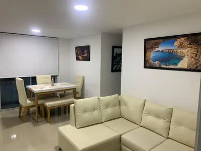 a living room with a couch and a table at Prada Caribe 303 in Coveñas