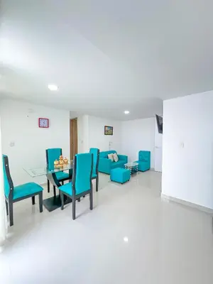 a waiting room with blue chairs and a table at Celeste Caribe 101A in Coveñas