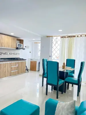 a kitchen and dining room with a table and chairs at Celeste Caribe 101A in Coveñas