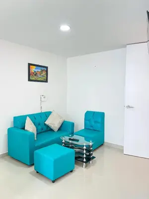 a living room with a blue couch and a coffee table at Celeste Caribe 101A in Coveñas