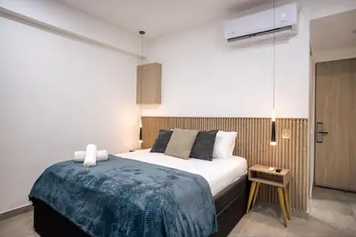 a bedroom with a bed with a blue blanket at Sea View Modern Loft in Cartagena de Indias