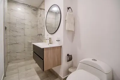 a bathroom with a toilet and a sink and a mirror at Sea View Modern Loft in Cartagena de Indias