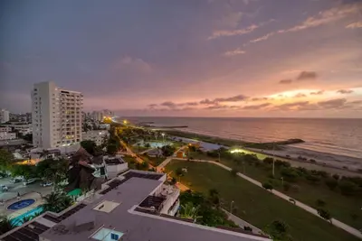 a view of a city with the ocean at night at Sea View Modern Loft in Cartagena de Indias
