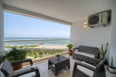 a living room with a large window with a view of the beach at Sea View Modern Loft in Cartagena de Indias