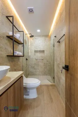 a bathroom with a toilet and a glass shower at Beach Front - Luxury High Rise - Dubai Style in Cartagena de Indias