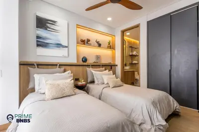 a bedroom with two beds and a ceiling fan at Beach Front - Luxury High Rise - Dubai Style in Cartagena de Indias