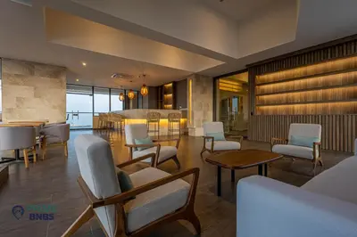 a lobby with chairs and tables and a bar at Beach Front - Luxury High Rise - Dubai Style in Cartagena de Indias