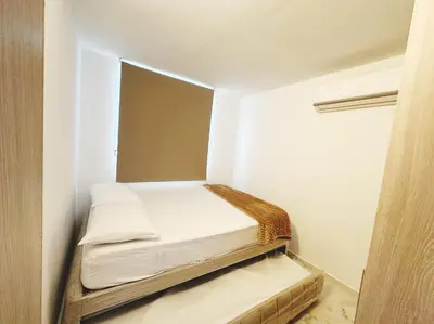 a small room with two beds and a mirror at Wow que vista!! Frente Ecoparque 7min CC Buenavista in Puerto Colombia