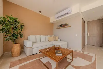 a living room with a white couch and a table at Condominio Moderno nuevo Trevi in Cartagena de Indias