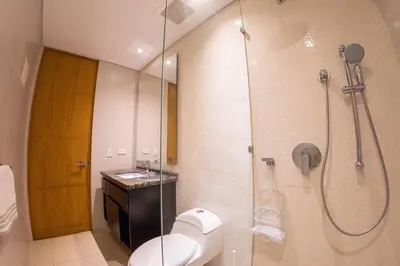 a bathroom with a shower with a toilet and a sink at luxury Aparment Ocean view H2 condominium apto 2105 in Cartagena de Indias