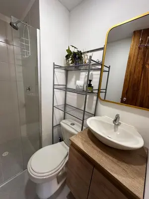 a bathroom with a toilet and a sink and a mirror at Apartment in Cartagena Sea View & Ocean View Cerca al centro Histórico in Cartagena de Indias