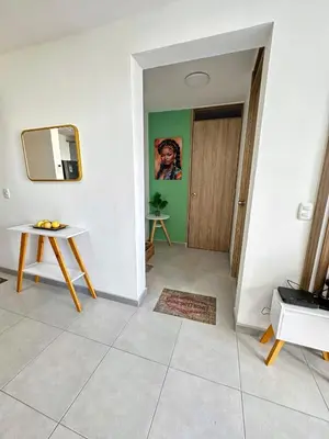 a living room with a table and a door at Apartment in Cartagena Sea View & Ocean View Cerca al centro Histórico in Cartagena de Indias