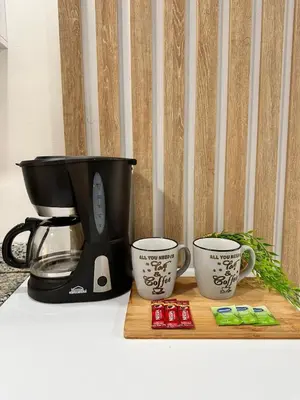 a coffee maker and two cups on a counter at Apartment in Cartagena Sea View & Ocean View Cerca al centro Histórico in Cartagena de Indias