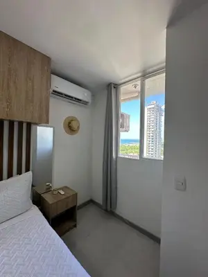 a bedroom with a bed and a window with a view at Apartment in Cartagena Sea View & Ocean View Cerca al centro Histórico in Cartagena de Indias