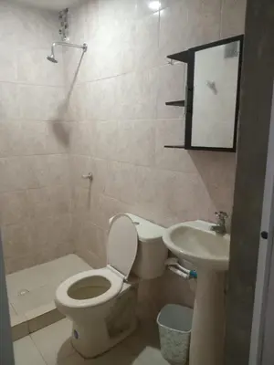 a bathroom with a toilet and a sink at Apartaestudio Barranquilla Calle 87 in Barranquilla
