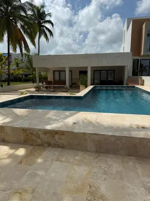 a swimming pool in front of a house at Cabaña Aledan in Coveñas