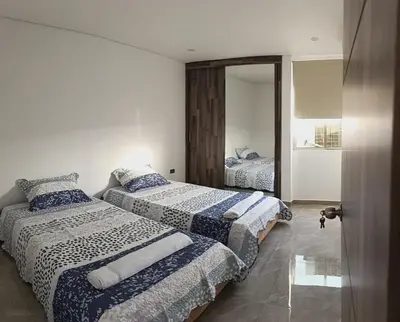 a bedroom with two beds and a mirror at Apartamento para estrenar in Barranquilla