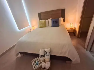 a bedroom with a large bed with two pairs of shoes at Cartagena playa uso exclusivo Serena del mar in Cartagena de Indias