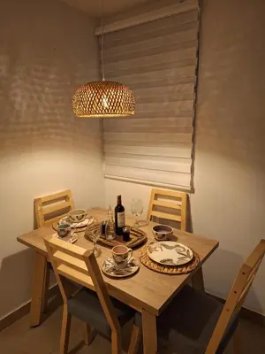 a wooden table with chairs and a bottle of wine at Cartagena playa uso exclusivo Serena del mar in Cartagena de Indias