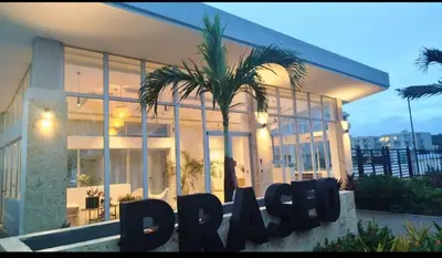 a building with a palm tree in front of it at Cartagena playa uso exclusivo Serena del mar in Cartagena de Indias