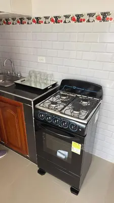a stove top oven in a kitchen with a sink at Hermoso estudio cerca del Centro Histórico in Cartagena de Indias