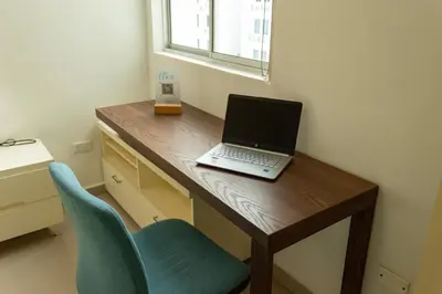 a laptop computer sitting on a wooden desk with a chair at Inca Caribe 302 in Coveñas
