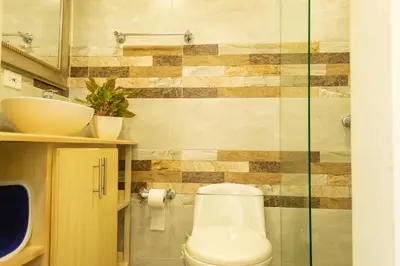 a bathroom with a toilet and a glass shower at Inca Caribe 302 in Coveñas