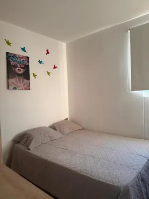 a bedroom with a bed with butterflies on the wall at ÁME Living in Cartagena de Indias