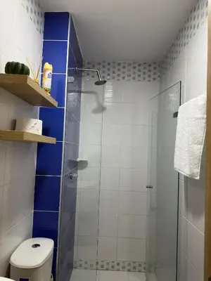 a bathroom with a glass shower with a toilet at ÁME Living in Cartagena de Indias