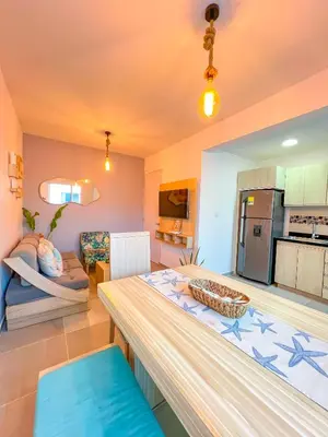 a kitchen and living room with a dining table at Cielo Caribe 501 in Coveñas