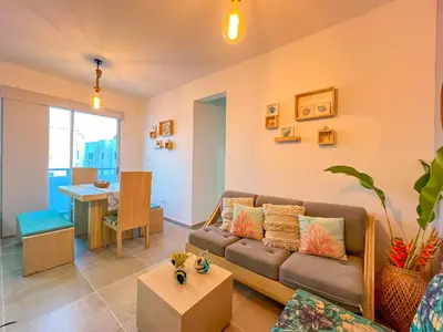 a living room with a couch and a table at Cielo Caribe 501 in Coveñas