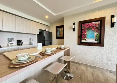 a kitchen with a counter with dishes on it at 1 bedroom luxury apartment with private jaccuzi in Cartagena de Indias